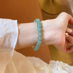 Close-up of green aventurine beaded bracelet with matte texture on a woman's wrist
