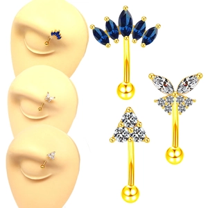 Gold eyebrow piercings with blue and white zircon stones in crown and butterfly shapes