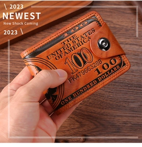 Close-up of vintage brown wallet with US dollar pattern held in hand on wooden table