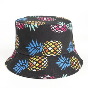 Detail of colorful geometric pineapple print on black reversible cotton sun hat