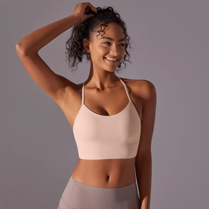 Detail of soft peach racerback yoga sports bra with wide elastic hem for fitness