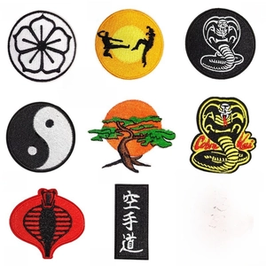 Detail of 9-piece embroidered patches with martial arts, cobra, and yin-yang designs