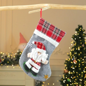 Plush Santa Claus Christmas stocking with grey felt body and red plaid cuff hanging