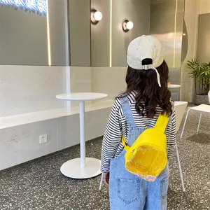 Bright yellow kids chest bag with transparent sequin pocket and adjustable strap