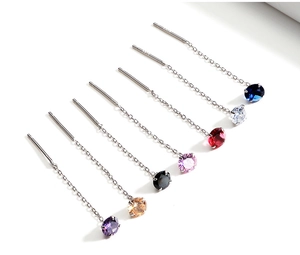 Macro detail of S925 sterling silver threader earrings with colorful zircon stones