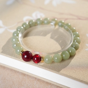 Close-up of natural Hetian jade and red agate beads on a retro style Chinese bracelet