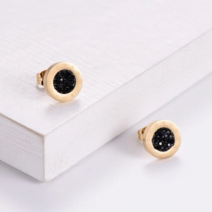 Titanium steel stud earrings featuring black center and gold Roman numerals on white background