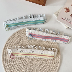 Floral fabric pencil cases with frill trim and large ring zippers in three colors