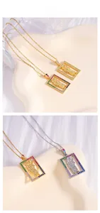 Detail showing rectangular religious pendants with colored zircons in gold and silver finish