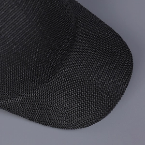 Close-up of black breathable knitted texture and premium matte finish on baseball cap brim