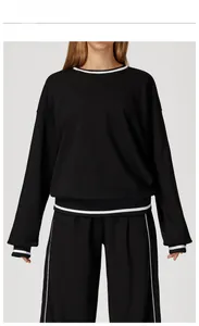 Detail of premium black sweatshirt with classic white double stripes on collar and cuffs