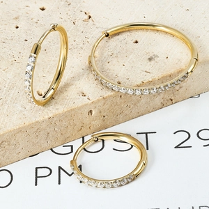 Golden stainless steel hoop earrings set with zircon stones in various sizes