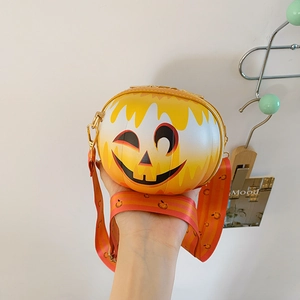 Detail of pumpkin-shaped shoulder bag with dripping wax effect and wink face design