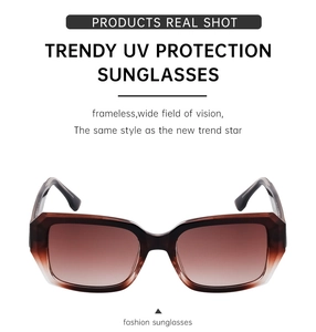 Detail of square oversized sunglasses featuring brown gradient lenses and UV protection