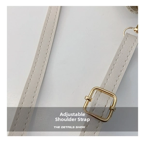 Detail of adjustable PU leather strap with gold buckle and fine lychee texture