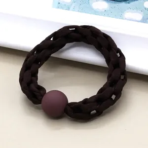 Detail of dark coffee braided elastic hair tie featuring a matte textured round bead