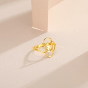 Detail of a golden stainless steel ring featuring an intricate Celtic knot design
