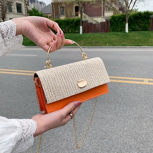 Orange and cream woven leather small handbag with golden metal handle and chain strap