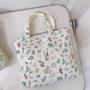 Detail of soft cream velvet fabric tote bag with colorful animal and floral patterns