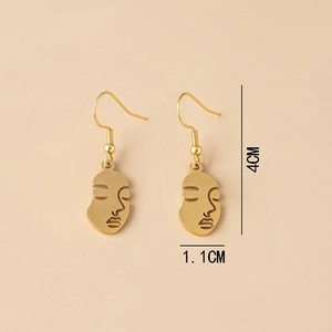Detailed view of golden abstract face earrings with dimensions 4cm height and 1.1cm width