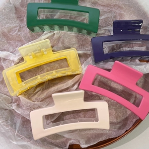 Five colorful hollow geometric hair claws in forest green, purple, yellow, pink and white