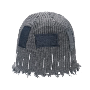 Distressed grey knit beanie with denim patches and raw edge stitching for street style