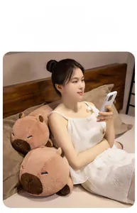 Ergonomic plush capybara leg pillow used as a cozy backrest in a bedroom setting