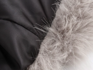 Detail shot of deep gray fabric texture with contrasting light gray faux fur collar
