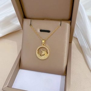 Gold unicorn necklace with zircon moon pendant in a jewelry gift box on soft cloth