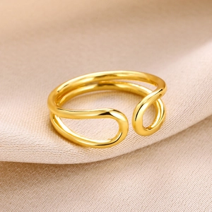 Macro detail of gold double-layer knotted ring with polished geometric teardrop design