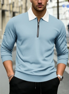 Close-up of men's quarter-zip polo shirt with light blue waffle texture and white collar