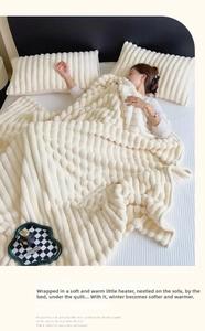 Detail of cream plush blanket featuring a 3D bubble texture and soft flannel fabric