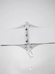 Detail of white wide lace-up corset belt with elastic band and champagne gold buckles
