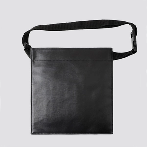 Detailed view of black makeup brush organizer bag with adjustable shoulder strap and buckle