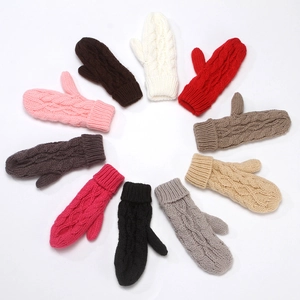 Flat lay of colorful knitted winter mittens in ten vibrant colors on white background