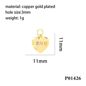 Macro detail of copper gold plated heart charm with Love engraving and size specs
