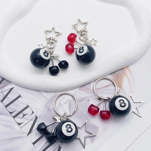 Metal cherry and 8-ball keychains with silver stars and red or black crystal accents