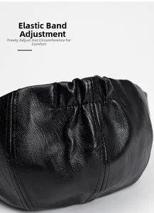Detail of adjustable elastic band on black PU leather newsboy cap for size adjustment