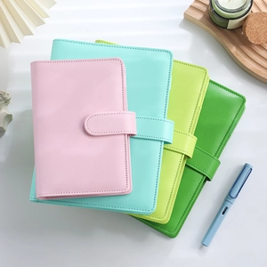 Pastel PU leather budget binders stacked with magnetic closure and blue fountain pen
