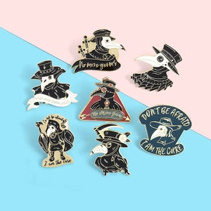 Detailed view of seven enamel plague doctor pins featuring crow motifs and gold metal edges