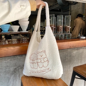 Detailed view of white teddy fleece tote bag with cute bear and dog cartoon embroidery