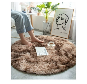 Detail of soft brown gradient plush round rug in a cozy living room setting