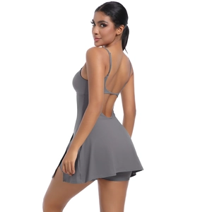Detail of cross-back straps and open back design on grey athletic tennis dress