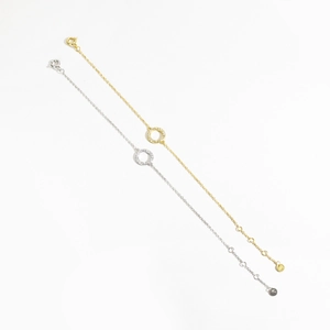 Macro detail of S925 sterling silver stamp on gold and silver minimalist bracelets