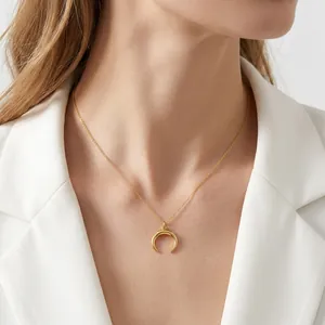 Minimalist 18K gold horn pendant necklace worn by a model for a chic daily style