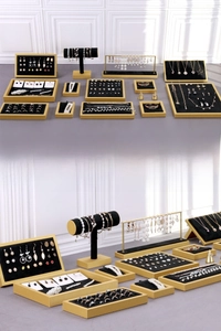 Macro view of black velvet jewelry display stands with elegant golden frames