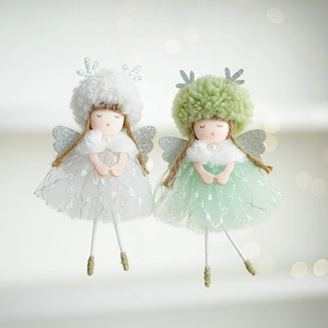 Detail of plush Christmas angel dolls with sequin wings and furry hats for tree decor