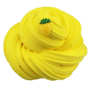 Detailed view of yellow pineapple butter slime with soft swirling texture and small fruit charm
