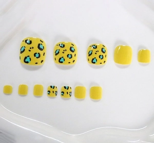 Detailed view of yellow and leopard print short square press-on toenails for women