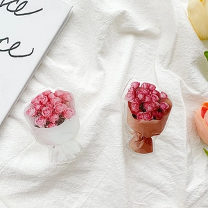 Detail of pink and red acrylic rose flower phone grips on a white textured background